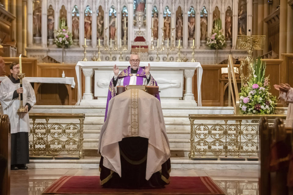 A service is performed as the the coffin of Cardinal George Pell lays in state at St. Mary's Cathedral in Sydney, Wednesday, Feb. 1, 2023. Pell, who was once the third-highest ranking cleric in the Vatican and spent more than a year in prison before his child abuse convictions were overturned in 2020, died in Rome on Jan. 10 at age 81. (Giovanni Portelli/Archdiocese of Sydney, Pool Photo via AP)