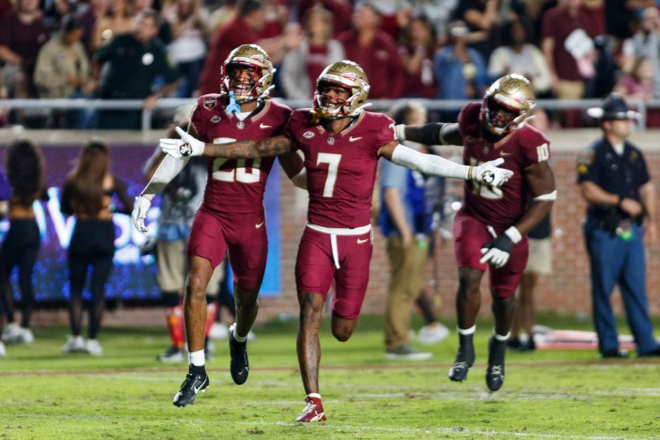 Nov 18, 2023; Tallahassee, Florida, USA; Florida State Seminoles defensive back Azareye'h Thomas (20) and defensive back Jarrian Jones (7) celebrate an interception against the North Alabama Lions during the third quarter at Doak S. Campbell Stadium. Mandatory Credit: Morgan Tencza-USA TODAY Sports