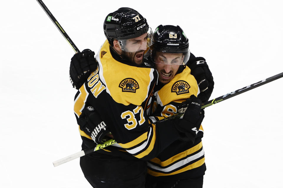 Boston Bruins' Patrice Bergeron celebrates his goal against the New York Islanders with teammate Brad Marchand in the third period of Game 2 during an NHL hockey second-round playoff series, Monday, May 31, 2021, in Boston. (AP Photo/Winslow Townson)