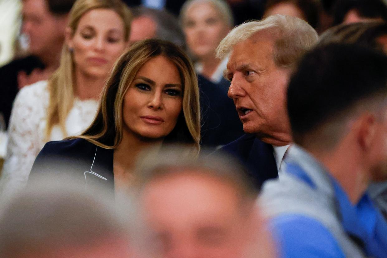 Republican presidential candidate and former U.S. President Donald Trump talks with his wife Melania as they attend the 2024 Senior Club Championship award ceremony in West Palm Beach, Florida on March 24, 2024.