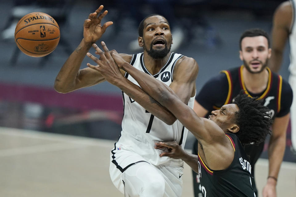 Cleveland Cavaliers' Collin Sexton, right, knocks the ball loose from Brooklyn Nets' Kevin Durant during the second half of an NBA basketball game, Wednesday, Jan. 20, 2021, in Cleveland. (AP Photo/Tony Dejak)