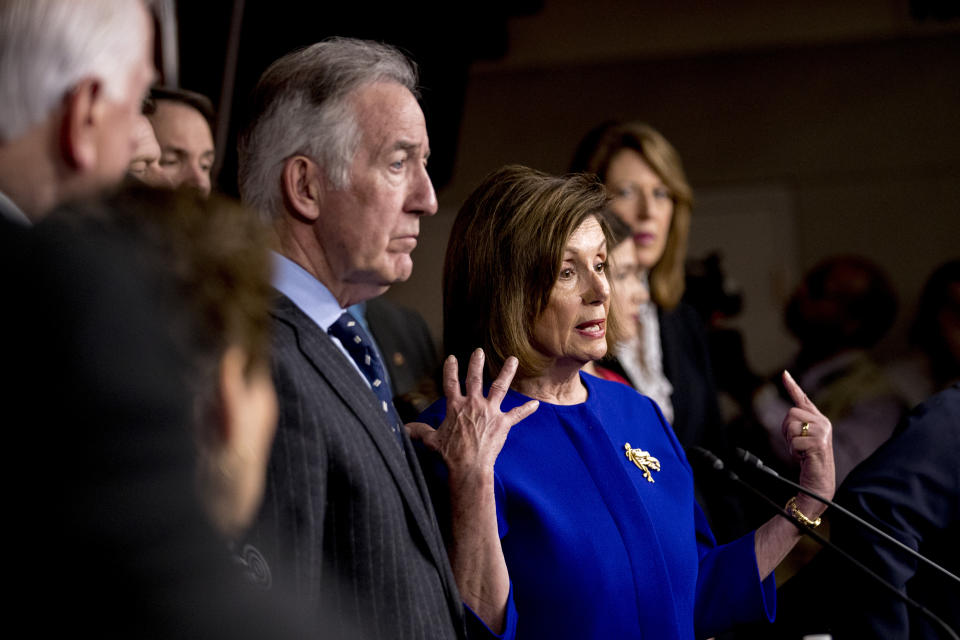 House Speaker Nancy Pelosi of Calif., accompanied by Chairman of the House Ways and Means Committee Richard Neal, D-Mass., left, and other House members, speaks at a news conference to discuss the United States Mexico Canada Agreement (USMCA) trade agreement, Tuesday, Dec. 10, 2019, on Capitol Hill in Washington. (AP Photo/Andrew Harnik)