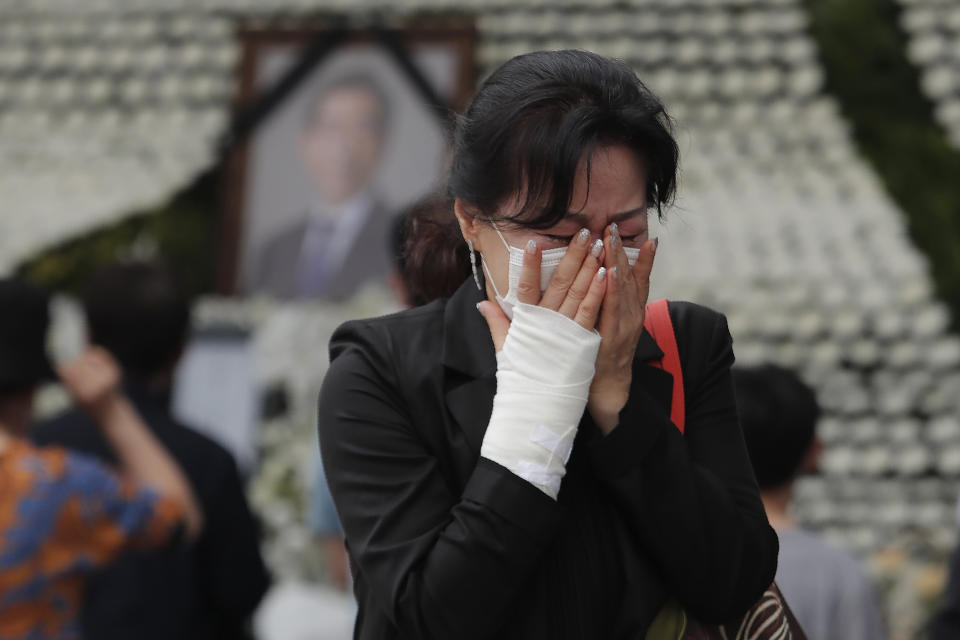 A mourner weeps at a memorial for the late Seoul Mayor Park Won-soon at City Hall Plaza in Seoul, South Korea, Sunday, July 12, 2020. The sudden death of Seoul's mayor, reportedly implicated in a sexual harassment complaint, has prompted an outpouring of public sympathy even as it has raised questions about a man who built his career as a reform-minded politician and self-described feminist. (AP Photo/Ahn Young-joon)