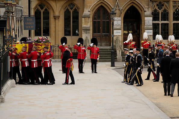 LONDON, ENGLAND - SEPTEMBER 19: The coffin of Queen Elizabeth II with the Imperial State Crown resting on top is carried by the Bearer Party into Westminster Abbey during the State Funeral of Queen Elizabeth II on September 19, 2022 in London, England. Elizabeth Alexandra Mary Windsor was born in Bruton Street, Mayfair, London on 21 April 1926. She married Prince Philip in 1947 and ascended the throne of the United Kingdom and Commonwealth on 6 February 1952 after the death of her Father, King George VI. Queen Elizabeth II died at Balmoral Castle in Scotland on September 8, 2022, and is succeeded by her eldest son, King Charles III.  (Photo by Christopher Furlong/Getty Images)