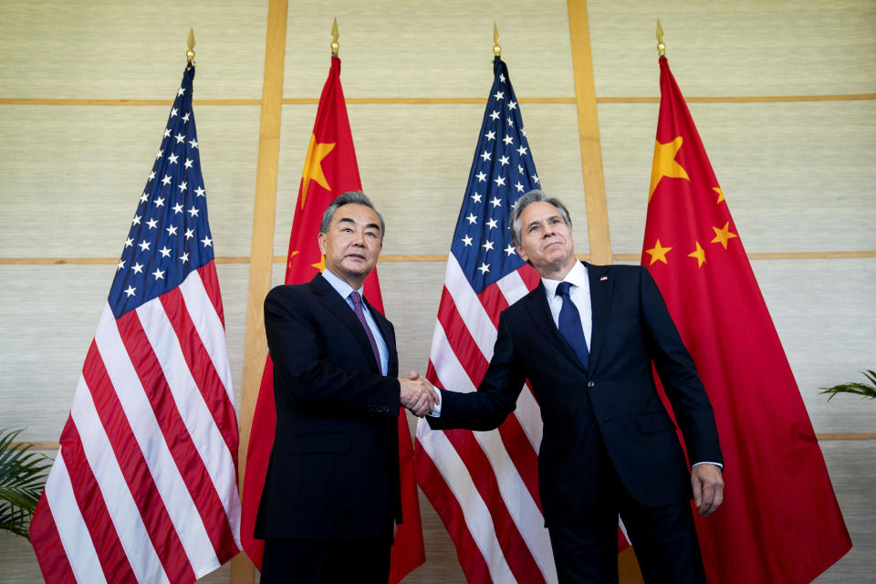 U.S. Secretary of State Antony Blinken, right, shakes hands with China's Foreign Minister Wang Yi during a meeting in Nusa Dua on the Indonesian resort island of Bali Saturday, July 9, 2022. (Stefani Reynolds/Pool Photo via AP)