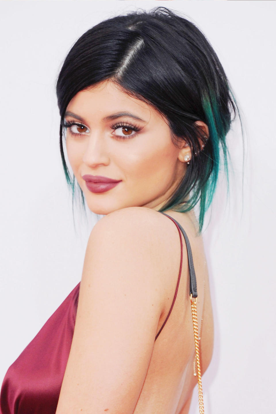 <p>A messy updo with teal strands peaking through at the 2014 American Music Awards in November.</p>