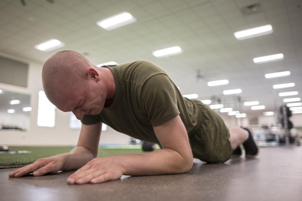 A U.S. Marine Corps recruit works out with a plank exercise during his physical therapy after sustaining an injury during training at the Marine Corps Recruit Depot, Wednesday, June 28, 2023, in Parris Island, S.C. (AP Photo/Stephen B. Morton)