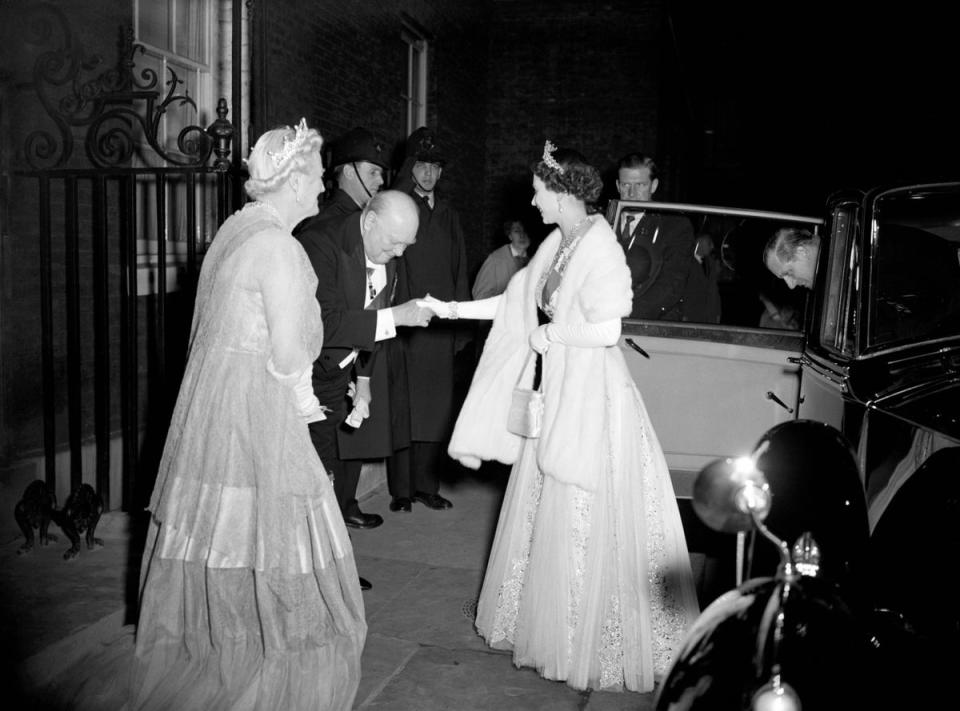 1955: Watched by Lady Churchill, Prime Minister Sir Winston Churchill bows low to Queen Elizabeth II as he welcomes her and the Duke of Edinburgh to 10 Downing Street for dinner (PA)