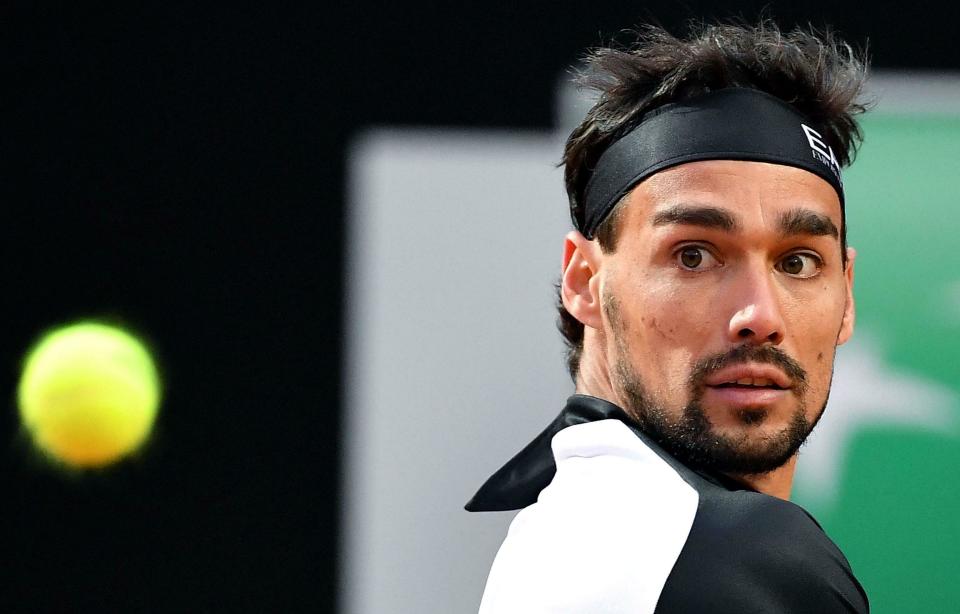 Italy's Fabio Fognini returns a backhand to Jo-Wilfried Tsonga, of France, during their men's singles first round match at the Italian Open tennis tournament in Rome, Monday, May 13, 2019. (Ettore Ferrari/ANSA via AP)