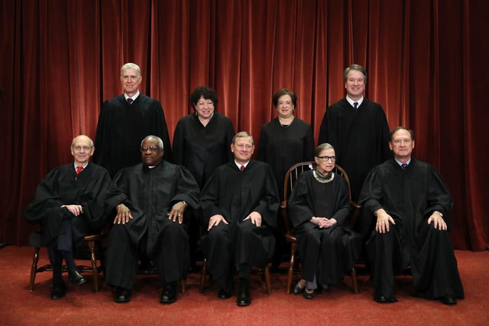 <div class="inline-image__caption"><p>Justice Ruth Bader Ginsburg, second from right in the first row, poses with her fellow justices in the East Conference Room at the Supreme Court building on Nov. 30, 2018. That year, as the #MeToo movement roiled America, she revealed her own experiences with sexual harassment and noted, “I think it’s about time. For so long, women were silent.”</p></div> <div class="inline-image__credit">Chip Somodevilla/Getty</div>