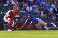 Chicago Cubs' Nelson Velazquez, right, scores past St. Louis Cardinals catcher Andrew Knizner during the 10th inning of a baseball game Sunday, June 26, 2022, in St. Louis. (AP Photo/Jeff Roberson)