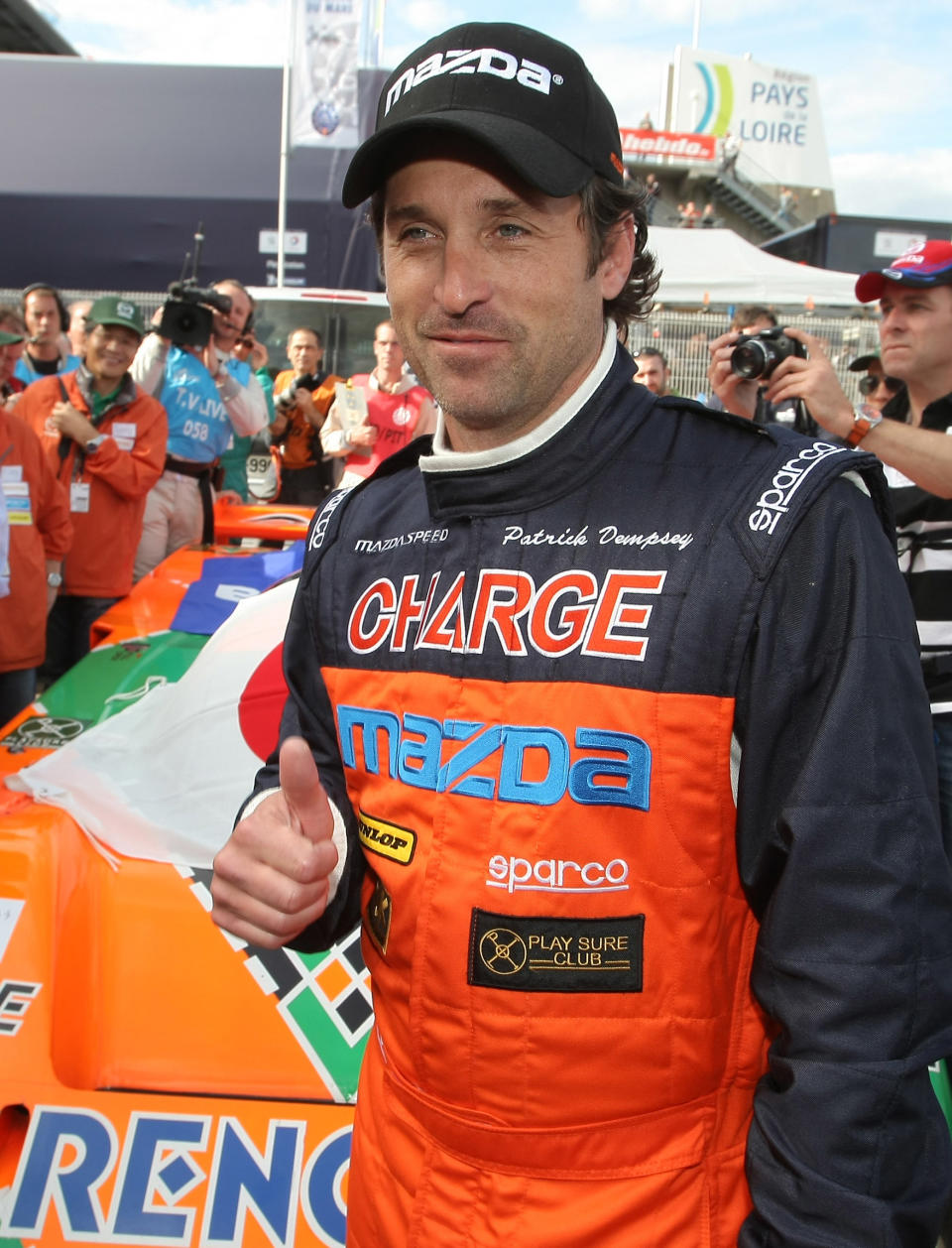 FILE - In this June 9, 2011 file photo, actor Patrick Dempsey poses for photographs in front of the Mazda 787 B, which won the race in 1991, in Le Mans, western France. Dempsey is producing and will be featured in "Road to Le Mans," a Velocity channel series that will follow the actor-race car driver as he prepares for the famed auto endurance race. (AP Photo/Vincent Michel, file)