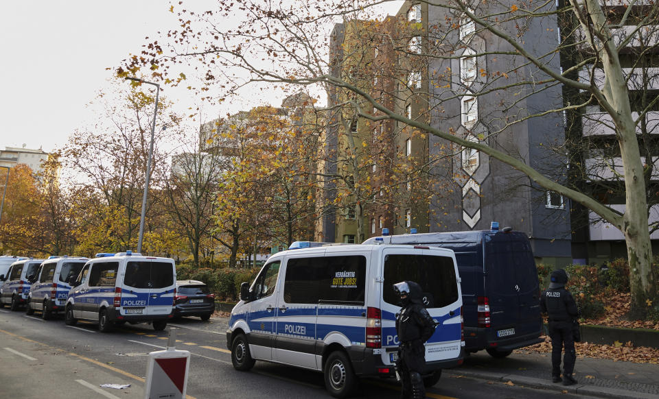 Police officers stand guard in front of an apartement building in Berlin, Germany, Tuesday, Nov. 17, 2020. Almost a year after the art theft in Dresden's Green Vault, police arrested three suspects on Tuesday morning in Berlin. Since the early morning, a total of 18 objects have been searched. (Annette Riedl/dpa via AP)