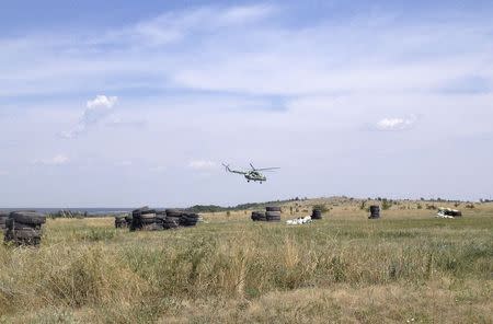 A Russian military helicopter takes off at a training site near the border with Ukraine in the Rostov region, August 7, 2014. REUTERS/Maria Tsvetkova
