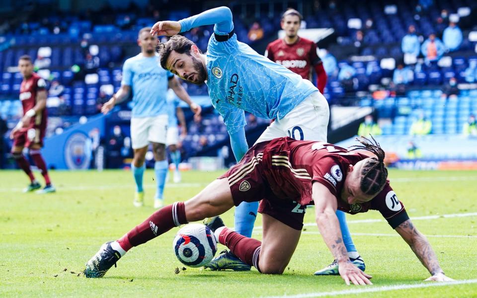 Bernardo Silva and Kalvin Phillips battle for the ball - GETTY IMAGES