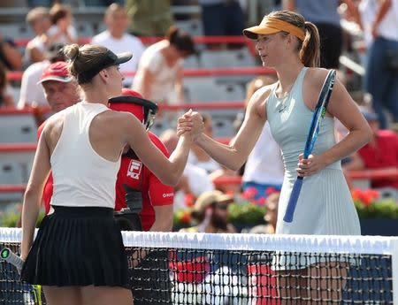 Aug 7, 2018; Montreal, Quebec, Canada; Maria Sharapova of Russia and Sesil Karatantcheva of Bulgaria (left) at the net after their match in the Rogers Cup tennis tournament at IGA Stadium. Mandatory Credit: Jean-Yves Ahern-USA TODAY Sports