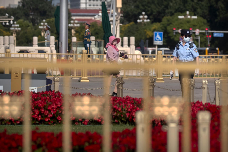 A Chinese police officer stands guard on Tiananmen Square in Beijing, Thursday, June 4, 2020. China tightened controls over dissidents while pro-democracy activists in Hong Kong and elsewhere sought ways to mark the 31st anniversary Thursday of the crushing of the pro-democracy movement centered on Beijing's Tiananmen Square. (AP Photo/Mark Schiefelbein)