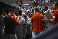 Washington Nationals left fielder Kyle Schwarber (12) celebrates a solo home run with teammates in the dugout during the first inning of a baseball game on Thursday, June 24, 2021, in Miami. (AP Photo/Mary Holt)