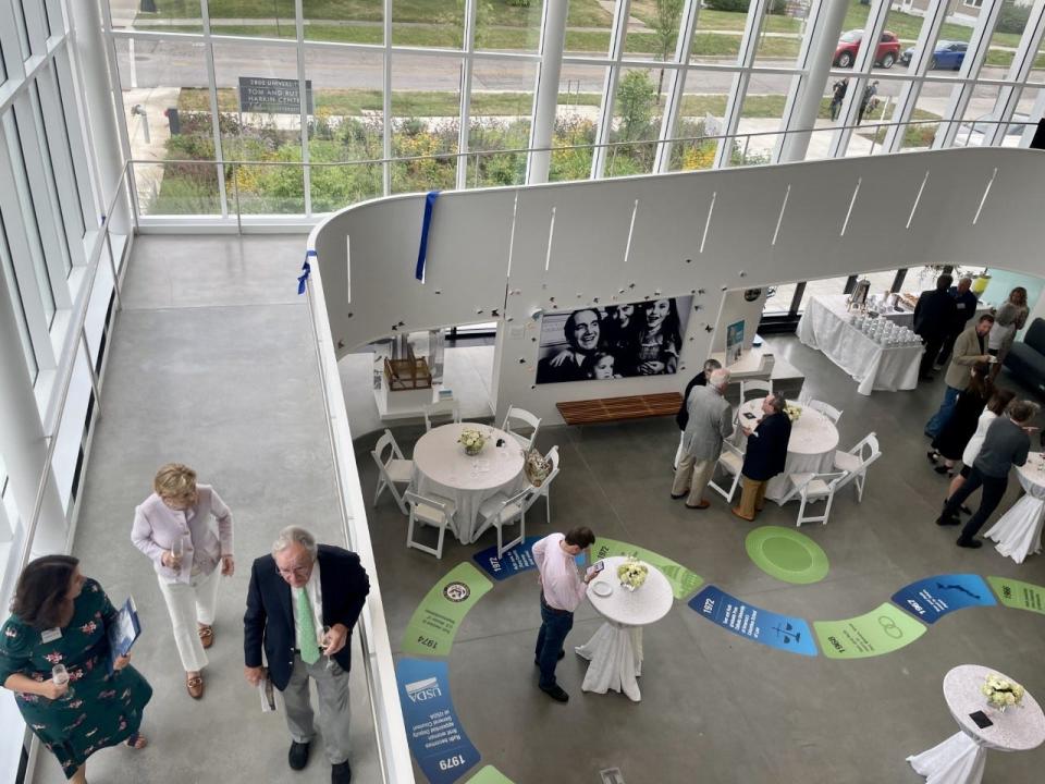 Tom and Ruth Harkin walk down the ramp inside the Tom and Ruth Harkin Center. The building's levels are connected by ramps, rather than stairs, for accessibility purposes.