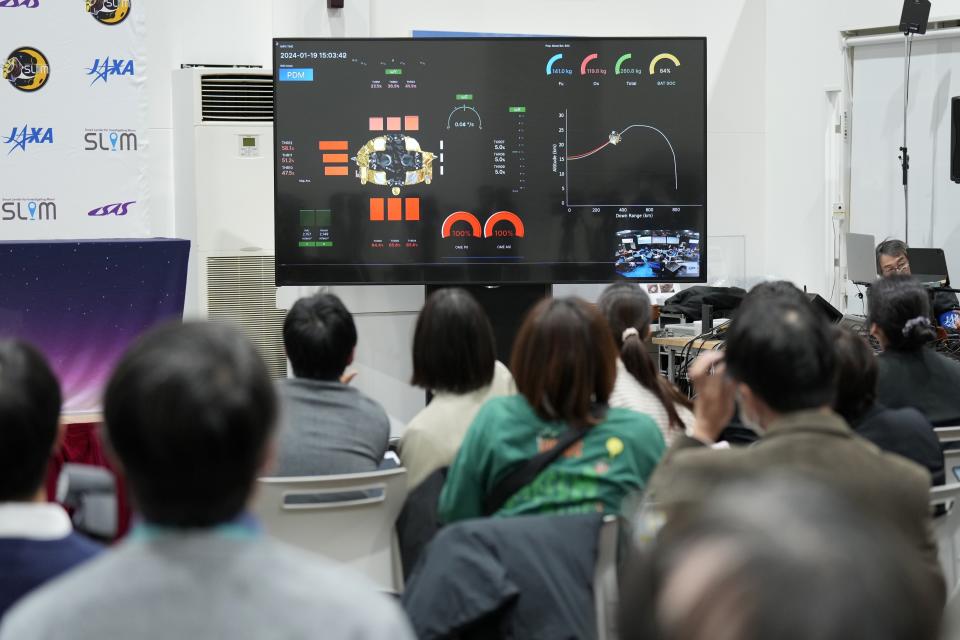 Journalists watch a live streaming of the pinpoint moon landing operation by the Smart Lander for Investigating Moon (SLIM) spacecraft at JAXA's Sagamihara Campus Saturday, Jan. 20, 2024, in Sagamihara near Tokyo. (AP Photo/Eugene Hoshiko)