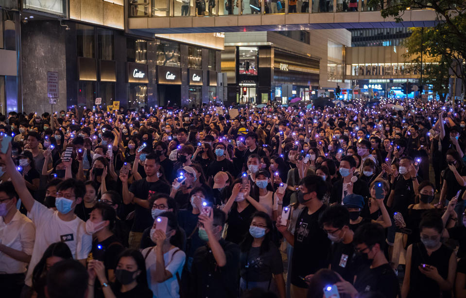 Protesters raise purple lights during a demonstration in Hong Kong.