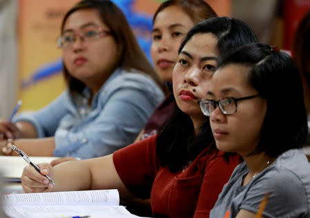 Filipino workers, including nurses applying to work in United Kingdom, attend a lecture at a review center for the International English Language Testing System or IELTS in Manila, Philippines, April 2, 2019. Picture taken April 2, 2019. REUTERS/Eloisa Lopez