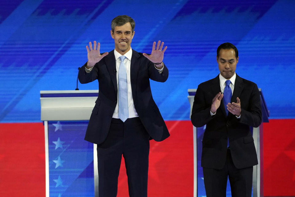 Former Texas Rep. Beto O'Rourke, left, and former Housing and Urban Development Secretary Julian Castro, right, take the stage Thursday, Sept. 12, 2019, during a Democratic presidential primary debate hosted by ABC at Texas Southern University in Houston. (AP Photo/David J. Phillip)