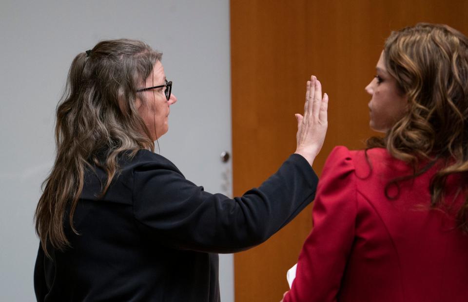 Jennifer Crumbley, left, raises her right hand as she is asked a questions regarding redacted Facebook Messenger conversations between she and her husband James Crumbley as her attorney Shannon Smith stands at right on Monday, Jan. 29, 2024 in the Oakland County courtroom of Judge Cheryl Matthews. Crumbley's son, Ethan Crumbley, is convicted on killing four students at Oxford High School in 2021.