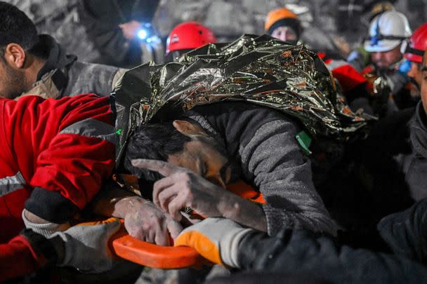 PHOTO: Syrian man Faez Ghanam saved by rescue workers from under the rubble after 210 hours, is carried to an ambulance in Hatay, southeastern Turkey, Feb. 14, 2023, a week after a deadly earthquake struck parts of Turkey and Syria. (Bulent Kilic/AFP via Getty Images)