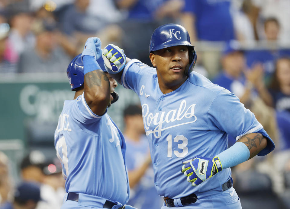 Kansas City Royals' Salvador Perez (13) celebrates with Nelson Velazquez, left, after hitting a home run during the third inning of a baseball game against the New York Yankees in Kansas City, Mo., Saturday, Sept. 30, 2023. (AP Photo/Colin E. Braley)