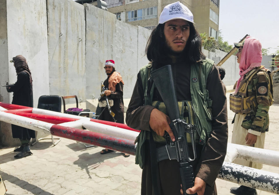 Taliban fighters stand guard at a checkpoint that was previously manned by American troops near the US embassy, in Kabul, Afghanistan, Tuesday, Aug. 17, 2021. The Taliban declared an "amnesty" across Afghanistan and urged women to join their government Tuesday, seeking to convince a wary population that they have changed a day after deadly chaos gripped the main airport as desperate crowds tried to flee the country. (AP Photo)