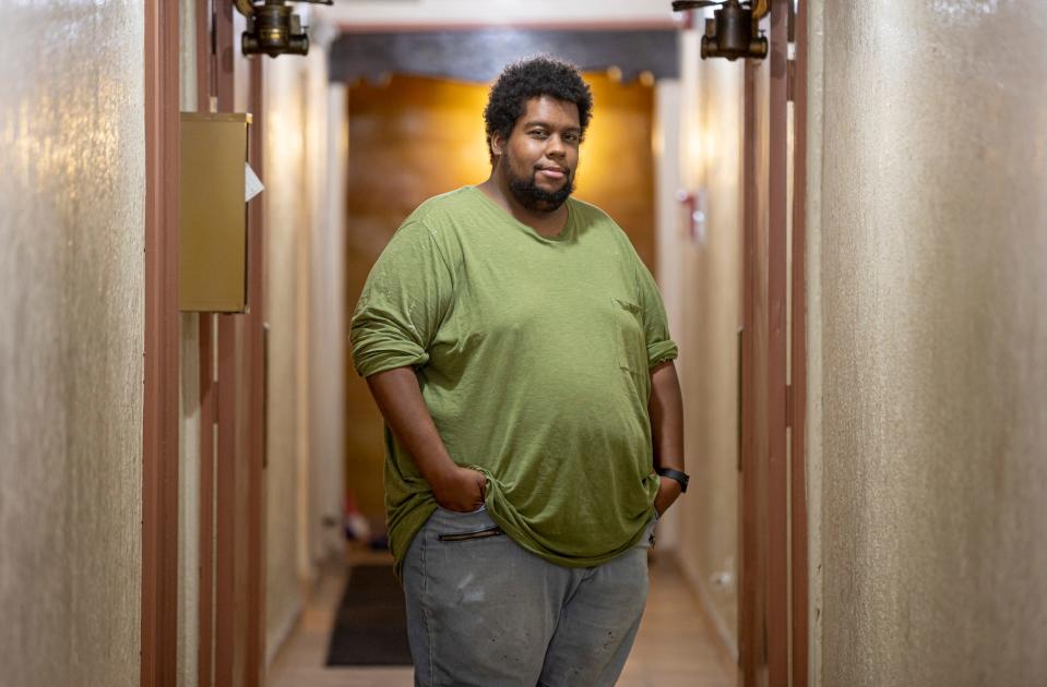 Portrait of Andre Foster, 30, of Detroit, in his apartment corridor, in Detroit on Wednesday, Aug.10, 2022. He used to park his car outside the building, which got towed in February during his doctors appointment on 6 mile road.