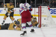 New York Rangers left wing Alexis Lafrenière (13) scores on Vegas Golden Knights goaltender Logan Thompson (36) during the third period of an NHL hockey game Wednesday, Dec. 7, 2022, in Las Vegas. (AP Photo/John Locher)