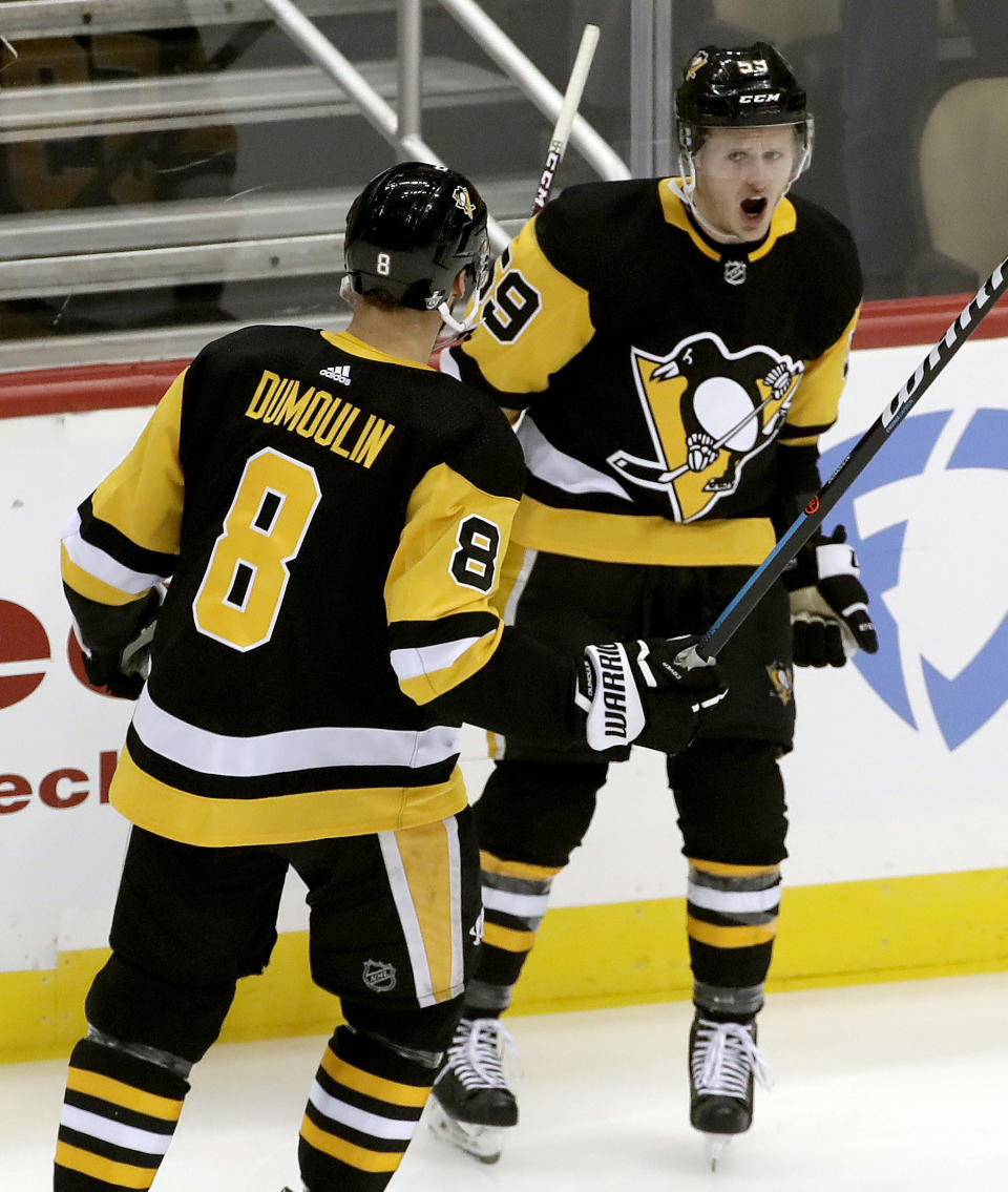 Pittsburgh Penguins' Jake Guentzel celebrates his goal with Brian Dumoulin during the first period in Game 4 of an NHL first-round hockey playoff series against the New York Islanders in Pittsburgh, Tuesday, April 16, 2019. (AP Photo/Gene J. Puskar)