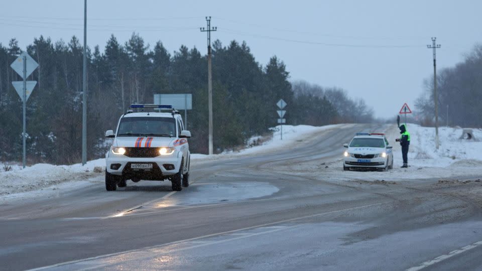 A vehicle belonging to the Russian Emergencies Ministry drives along a road near the crash site of the Russian Ilyushin Il-76 military transport plane outside the village of Yablonovo in the Belgorod region of Russia on January 24, 2024. - Stringer/Reuters