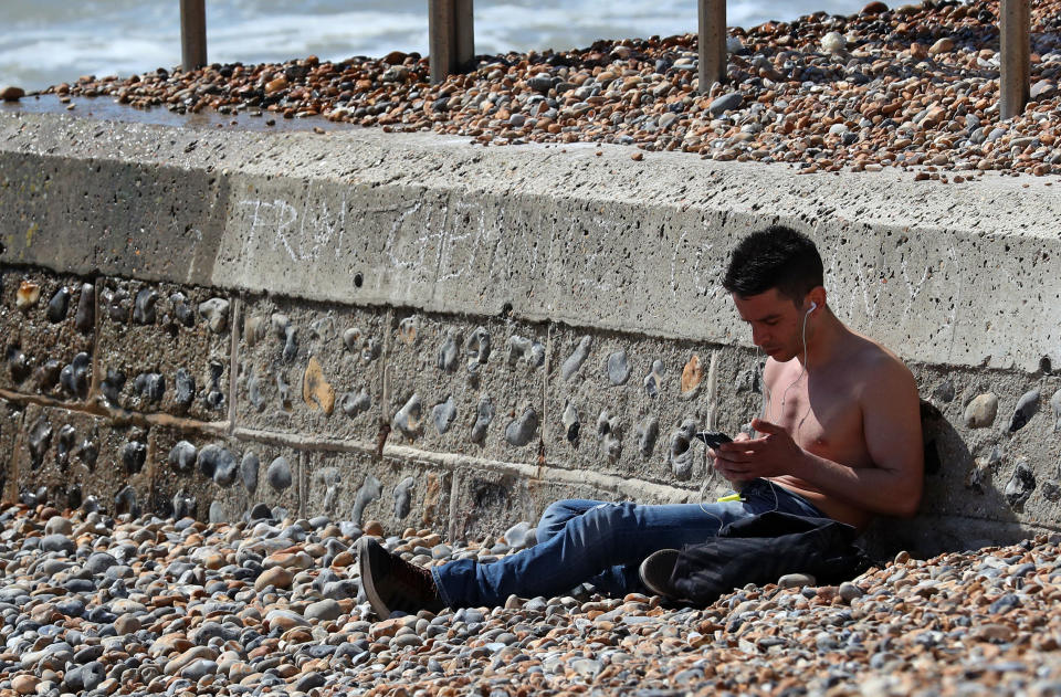 A man soaks up the sun in Brighton (Picture: PA)