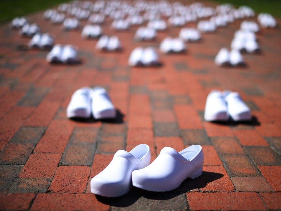 The National Nurses United union set out empty pairs of shoes representing nurses that they say have died from COVID-19 at a demonstration across from the White House, on May 7, 2020.