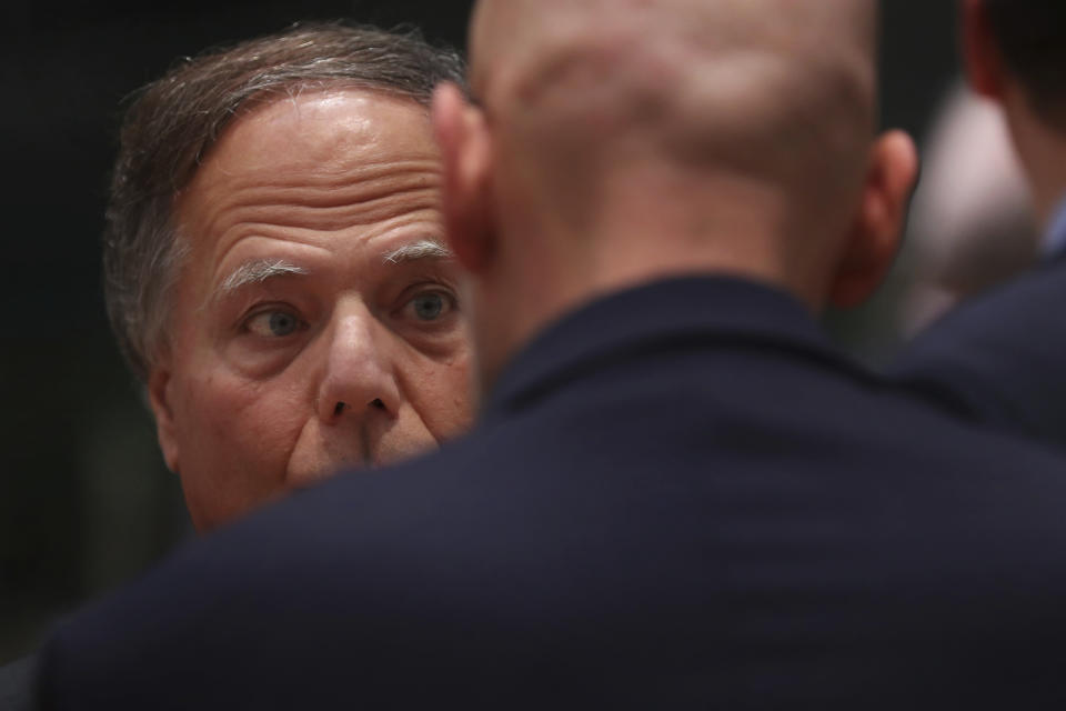 Italy's Foreign Minister Enzo Moavero, left, talks to a member of his delegation prior a meeting of EU Foreign Affairs ministers at the European Council headquarters in Brussels, Monday, Dec. 10, 2018. (AP Photo/Francisco Seco)