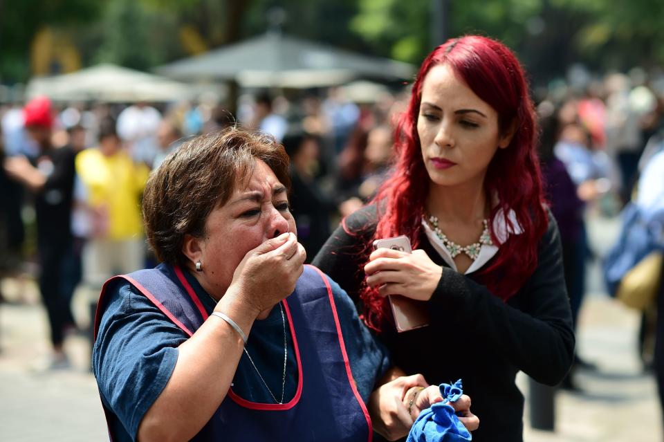 A woman reacts as a real quake rattles Mexico City on Tuesday&nbsp;as an earthquake drill was being held in the capital.