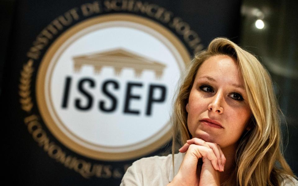 French far-right politician Marion Marechal looks on next to the logo of the ISSEP political science school in Lyon - AFP