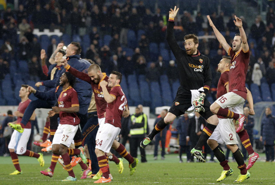AS Roma players celebrate at the end of a Serie A soccer match between AS Roma and Torino, at Rome's Olympic Stadium, Tuesday, March 25, 2014. AS Roma won 2-1. (AP Photo/Andrew Medichini)