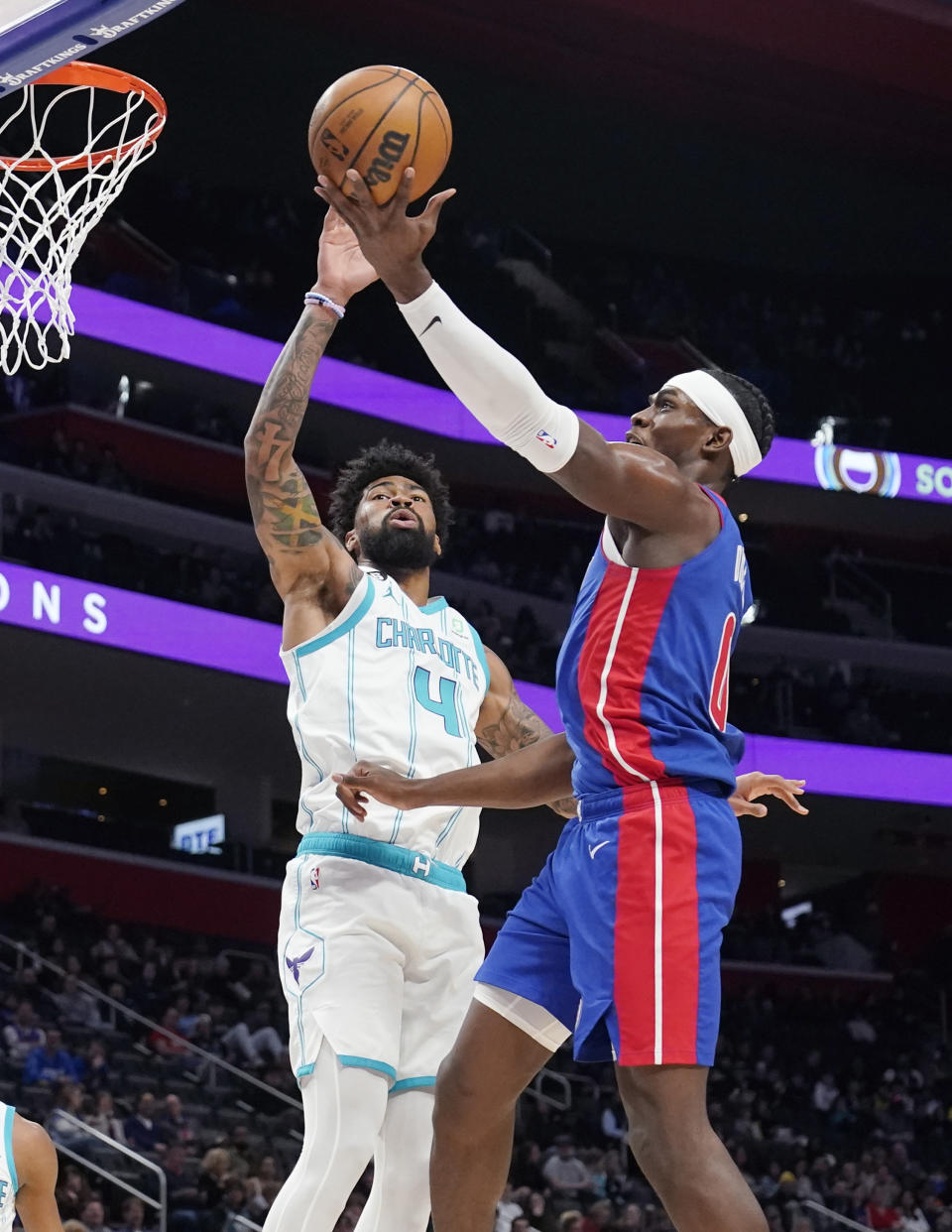 Detroit Pistons center Jalen Duren (0) attempts a layup as Charlotte Hornets center Nick Richards (4) defends during the first half of an NBA basketball game, Thursday, March 9, 2023, in Detroit. (AP Photo/Carlos Osorio)