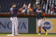 Atlanta Braves' Orlando Arcia, left, and Ronald Acuna Jr. celebrate after a baseball game against the Washington Nationals at Nationals Park, Tuesday, Sept. 27, 2022, in Washington. The Braves won 8-2. (AP Photo/Jess Rapfogel)