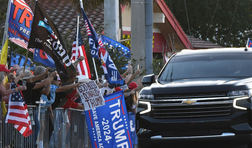 WEST PALM BEACH, FLORIDA, UNITED STATES - APRIL 4: Supporters of former U.S. President Donald Trump wave signs and flags as the motorcade carrying Trump makes its way back to his Mar-a-Lago Club following his arraignment in New York on April 4, 2023 in West Palm Beach, Florida. (Photo by Paul Hennessy/Anadolu Agency via Getty Images)