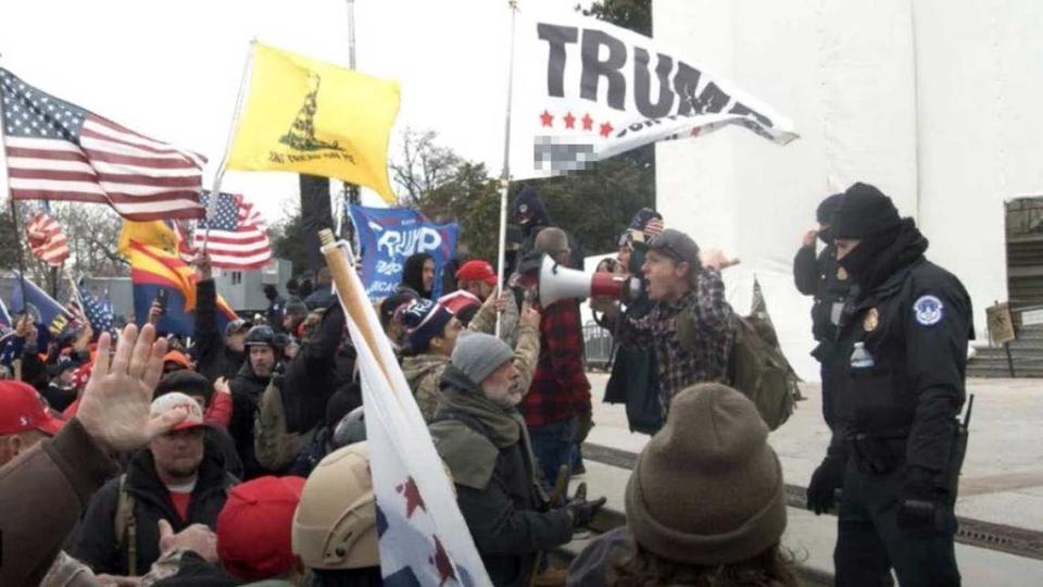 A federal complaint filed against Sean Michael McHugh, 34, of Auburn â seen holding a megaphone in this photo provided by prosecutors â alleges that McHugh sprayed U.S. Capitol Police officers with a chemical substance and assaulted them with a metal sign during the Jan. 6, 2021, insurrection at the U.S. Capitol.