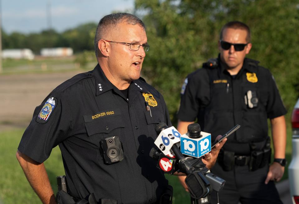 Columbus police Assistant Chief Greg Bodker speaks at a press conference Thursday evening about the armed robbery spree earlier that left a Columbus police officer critically wounded and one of the three suspects dead on Interstate 70 following a shootout. Two suspects remained at-large.