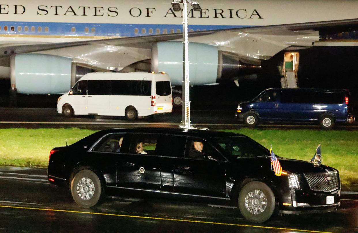 Biden is driven away in an armoured car (Reuters)