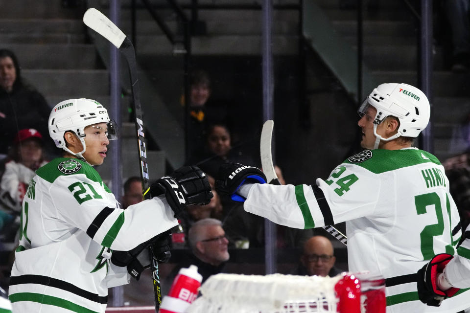 Dallas Stars left wing Jason Robertson (21) celebrates his goal against the Arizona Coyotes with Stars center Roope Hintz (24) during the second period of an NHL hockey game in Tempe, Ariz., Thursday, Nov. 3, 2022. (AP Photo/Ross D. Franklin)