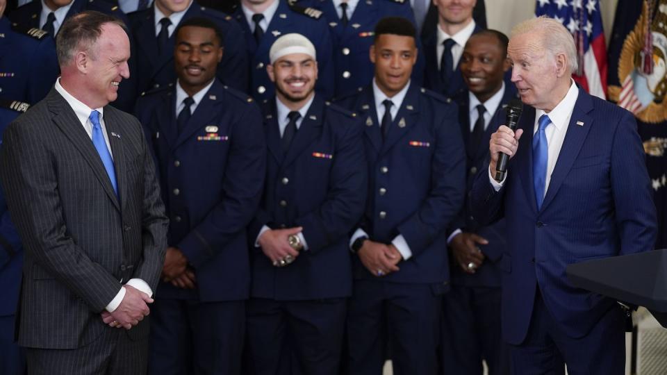 Air Force Academy head coach Troy Calhoun and his football players smile as President Joe Biden speaks during an event to present the Commander-in-Chief's trophy to the Air Force Academy in the East Room of the White House April 28 in Washington. (Evan Vucci/AP)