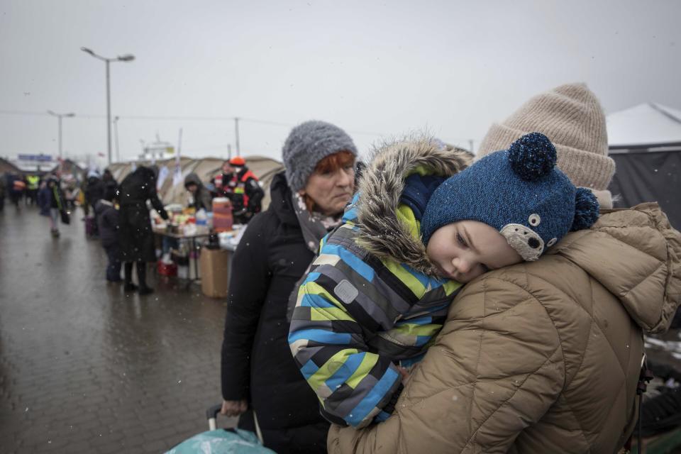 A boy rest his head on his mother's shoulder after fleeing from Ukraine, at the border crossing in Medyka, Poland, Wednesday, March 9, 2022. U.N. officials said that the Russian onslaught has forced 2 million people to flee Ukraine. It has trapped others inside besieged cities that are running low on food, water and medicine amid the biggest ground war in Europe since World War II. (AP Photo/Visar Kryeziu)